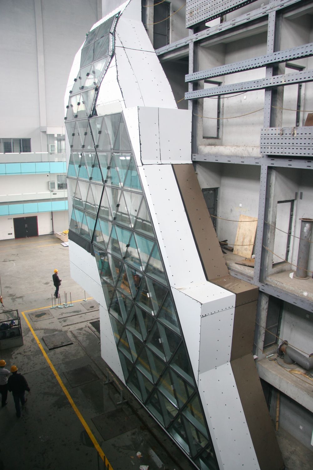 Faceted curtain wall performance mock-up with triangular glazing in a test laboratory