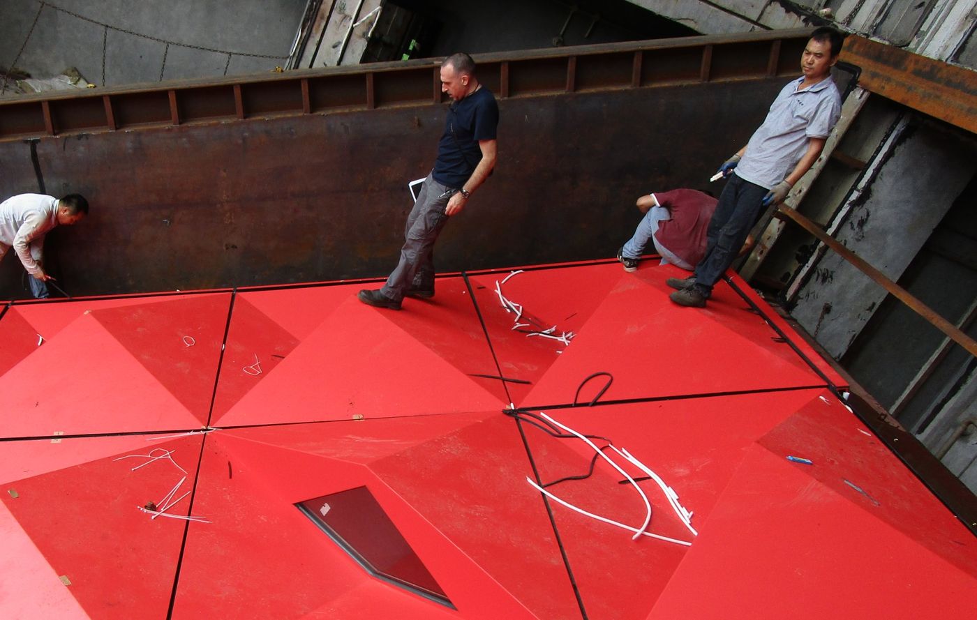Inspecting a cladding performance mock-up during installation at a test laboratory